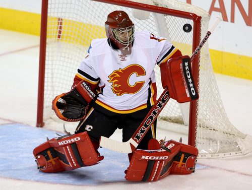 Winnipeg Jets' Evander Kane (9) hits the post behind Calgary Flames' goaltender Jonas Hiller (1) early during the first period of NHL hockey action in Winnipeg, Saturday, October 4, 2014. (TREVOR HAGAN/WINNIPEG FREE PRESS)