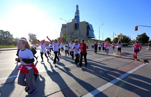 Participants in the Run for the Cure pass the Canadian Museum for Human Rights, Sunday, October 5, 2014. (TREVOR HAGAN/WINNIPEG FREE PRESS)