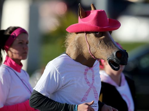 A participant wearing a horse head during the Run for the Cure nears the finish line, Sunday, October 5, 2014. (TREVOR HAGAN/WINNIPEG FREE PRESS)