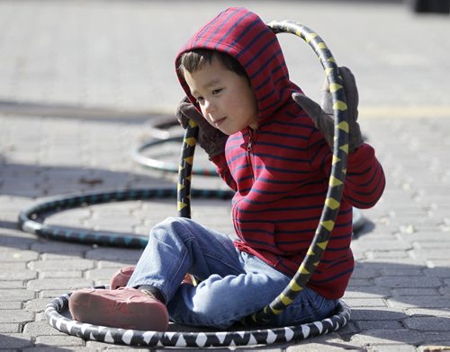 Aiden Pomrenke, 4, checks out the hula hoops for sale at the Farmers Market at The Forks, Sunday, October 5, 2014. (TREVOR HAGAN/WINNIPEG FREE PRESS)