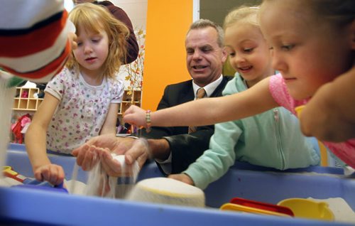 Education and Advanced Learning Minister James Allum tries out the sand table with students in the new kindergarten classroom in École Robert Browning School Monday made possible through the province's smaller classes initiative announced the Manitoba Gov't in partnership with school divisions has hired over 100 new teachers this year bringing the total to 315.   Bruce Owen story.  Wayne Glowacki/Winnipeg Free Press Oct. 6 2014