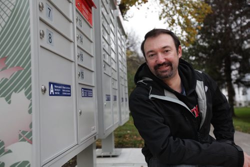 Dan Trudeau, owner of new company - YouHaveMail which is a mail delivery service from community mailboxes to homes for a fee.  Photo taken on Ruperstland and Scotia at set of community boxes.  See Cash story.   Oct 07,  2014 Ruth Bonneville / Winnipeg Free Press