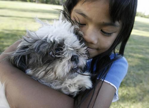 John Woods / Winnipeg Free Press / August 3/07- 070803   Jaimee  Montenegro plays with her puppy Sheila and her parents at the Assiniboine Park Friday August 03/07.