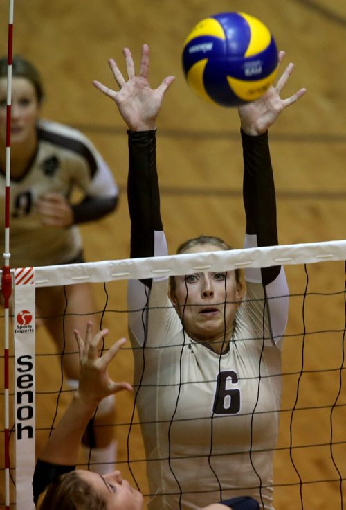 University of Manitoba Bisons' Rachel Cockrell blocks a hit by the Calgary Dinos during their game at Investors Group Athletic Centre, Thursday, October 9, 2014. (TREVOR HAGAN/WINNIPEG FREE PRESS)