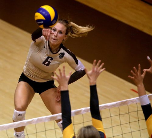 University of Manitoba Bisons' Rachel Cockrell hits over the Calgary Dinos block during their game at Investors Group Athletic Centre, Thursday, October 9, 2014. (TREVOR HAGAN/WINNIPEG FREE PRESS)