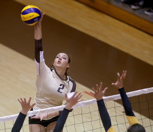 University of Manitoba Bisons' Kalena Schulz hits over the Calgary Dinos block during their game at Investors Group Athletic Centre, Thursday, October 9, 2014. (TREVOR HAGAN/WINNIPEG FREE PRESS)