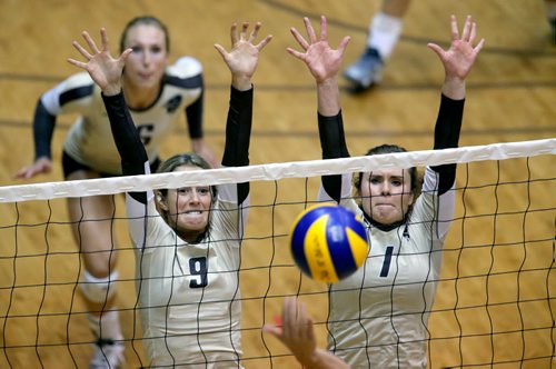 University of Manitoba Bisons' Brittany Habing and Cassie Bujan block the ball during their game against the Calgary Dinos at Investors Group Athletic Centre, Thursday, October 9, 2014. (TREVOR HAGAN/WINNIPEG FREE PRESS)