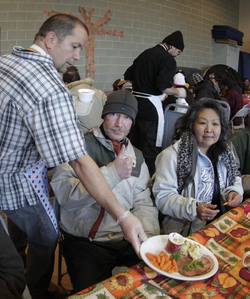 Shawn Marko gives the thumbs up as volunteer Shawn Nason serves him a ham Thanksgiving meal Friday morning at the Agape Table. The many volunteers on hand serving the meals expected 400 guests at the special event. The Agape Table has been serving nutritious meals in the West Broadway community since 1980 for people struggling to afford food. Wayne Glowacki/Winnipeg Free Press Oct. 10 2014