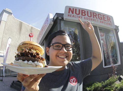 Ivan Valencia, G.M. and part owner of Nuburger on Stradbrook Ave. with a Shang-Awesome beef burger. Story about this burger joint that changed its name to unconfuse some customers. It sells beef, chicken and bison burgers (and veggie burgers) but it's not a vegan restaurant. Geoff Kirbyson  story. Wayne Glowacki/Winnipeg Free Press Oct. 10 2014