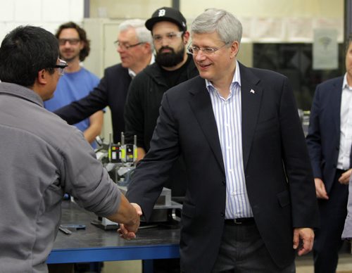 Prime Minister Stephen Harper at photo opportunity at Manitoba Institute of Trades and Technology  Henlow Campus, 130 Henlow Bay. Here he shakes hands with a student at the college. BORIS MINKEVICH / WINNIPEG FREE PRESS October 10, 2014