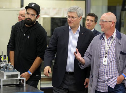 Prime Minister Stephen Harper at photo opportunity at Manitoba Institute of Trades and Technology  Henlow Campus, 130 Henlow Bay. He was joined by right, Dan Zvanovec, Millwright Instructor. No ID on guy on left. BORIS MINKEVICH / WINNIPEG FREE PRESS October 10, 2014
