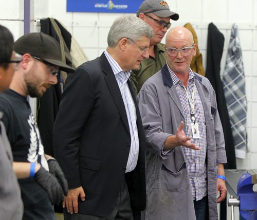 Prime Minister Stephen Harper at photo opportunity at Manitoba Institute of Trades and Technology  Henlow Campus, 130 Henlow Bay. He was joined by right, Dan Zvanovec, Millwright Instructor. BORIS MINKEVICH / WINNIPEG FREE PRESS October 10, 2014