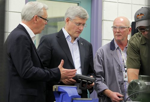 Prime Minister Stephen Harper at photo opportunity at Manitoba Institute of Trades and Technology  Henlow Campus, 130 Henlow Bay. He was joined by left, Greg Selinger, Premier of Manitoba and right, Dan Zvanovec, Millwright Instructor. BORIS MINKEVICH / WINNIPEG FREE PRESS October 10, 2014