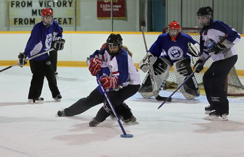 Alberta's player #4 Rachel Grant (white), works to score against BC during the Ringette Challenge Weekend that started Friday at the Keith Bodley Arena.  Standup photo.  Oct 10,  2014 Ruth Bonneville / Winnipeg Free Press