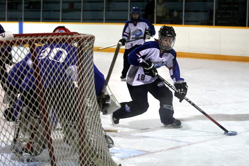 Alberta's player #18 Kate Henderson works to get the puck past BC goalie during the Ringette Challenge Weekend that started Friday at the Keith Bodley Arena.  Standup photo.  Oct 10,  2014 Ruth Bonneville / Winnipeg Free Press