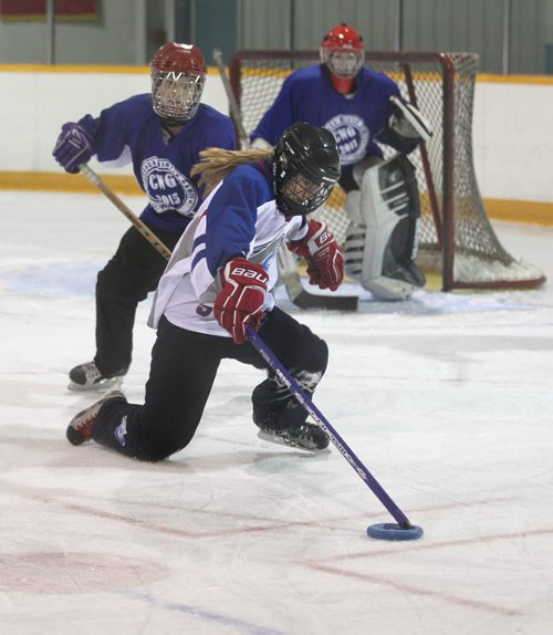 Alberta's player #4 Rachel Grant (white), works to score against BC during the Ringette Challenge Weekend that started Friday at the Keith Bodley Arena.  Standup photo.  Oct 10,  2014 Ruth Bonneville / Winnipeg Free Press