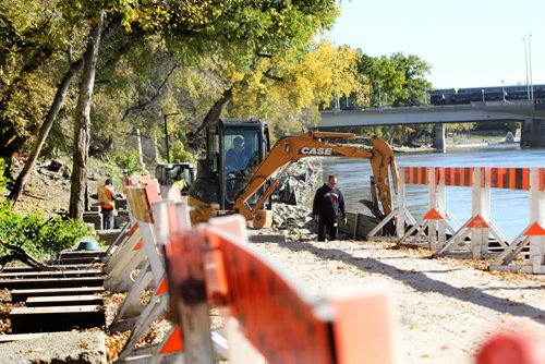 The River walk along the Assiniboine undergoes some reinforcements after a summer of high water caused damage to the shoreline and walkway. Pedestrians enjoy walking in the open portions on it Saturday in beautiful sunny weather.    Standup photo Oct 11,  2014 Ruth Bonneville / Winnipeg Free Press