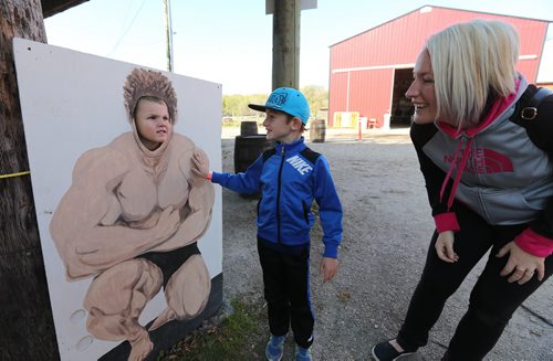 Dallas Slater, 6, checks out his little brother (six years old) BronsenÄôs new muscles along with their mom Pamela at Six Pines Haunted Attractions part north of Winnipeg on Sat., Oct. 11, 2014. The interactive attractions will be open until Halloween. Photo by Jason Halstead/Winnipeg Free Press