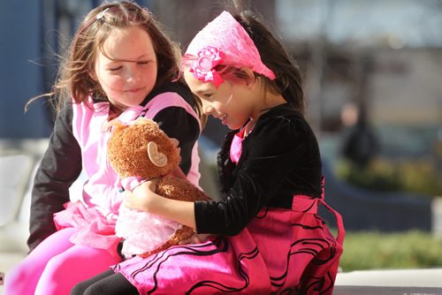 Eight-year-old Isabella Burgos - transgender (in dress) plays with her friend Zoey Thiessen (7yrs) at Transcona Centennial Square Saturday after a rally was held in support of her wanting to live her life as a girl even though she is biologically a boy. Her parents - Izzy (mom) and Dale (dad), support her decision fully.   See Alex Paul story. Oct 11,  2014 Ruth Bonneville / Winnipeg Free Press