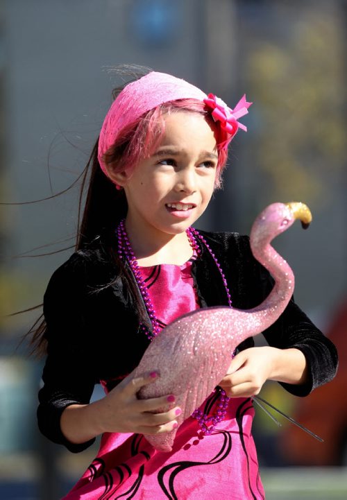 Eight-year-old Isabella Burgos - transgender plays with a pink flamingo at Transcona Centennial Square Saturday after a rally was held in support of her wanting to live her life as a girl even though she is biologically a boy. Her parents - Izzy (mom) and Dale (dad), support her decision fully.   See Alex Paul story. Oct 11,  2014 Ruth Bonneville / Winnipeg Free Press