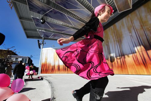 Eight-year-old Isabella Burgos - transgender,  races around the stage at Centennial Square Saturday in Transcona after a rally was held in support of her wanting to live her life as a girl even though she is biologically a boy. Her parents - Izzy (mom) and Dale (dad), support her decision fully.   See Alex Paul story. Oct 11,  2014 Ruth Bonneville / Winnipeg Free Press