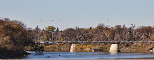 Canoeists make their way along the Red River towards the BDI footbridge Monday morning.  141013 October 13, 2014 Mike Deal / Winnipeg Free Press