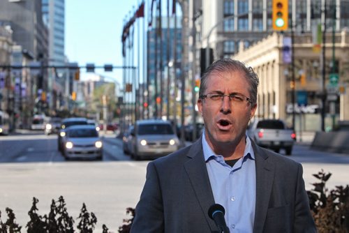 Mayoral candidate Gord Steeves makes a policy statement regarding traffic at the intersection of Portage and Main Monday afternoon.  141013 October 13, 2014 Mike Deal / Winnipeg Free Press