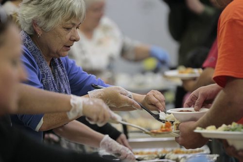 October 13, 2014 - 141013  -   People are served by volunteers at the Got Bannock Village Feast at The Indian and Metis Friendship Centre Monday, October 13, 2014. The Bannock Lady, Althea Guiboche, says they are 'trying to bring more humanity back to the poverty-stricken and let people know we care." John Woods / Winnipeg Free Press