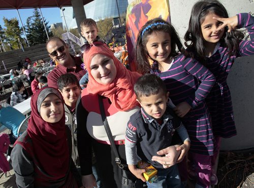 October 13, 2014 - 141013  -  Baraa and Riyadh Diab and their family are photographed during a KidBridge Thanksgiving feast. KidBridge launched their "First Nations, All Nations: Setting the Table" project with a intercultural Thanksgiving potluck feast at The Forks  Monday, October 13, 2014. John Woods / Winnipeg Free Press