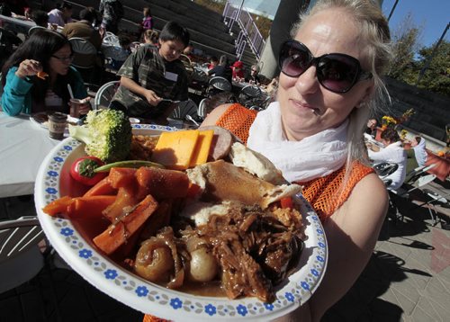 October 13, 2014 - 141013  - Diane Sawka, Kidbridge volunteer, shows off some goodies during a KidBridge Thanksgiving feast. KidBridge launched their "First Nations, All Nations: Setting the Table" project with a intercultural Thanksgiving potluck feast at The Forks  Monday, October 13, 2014. John Woods / Winnipeg Free Press