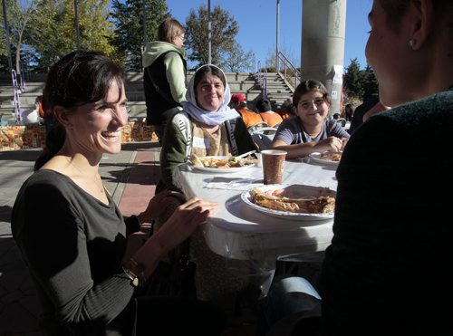 October 13, 2014 - 141013  -  Lorelle Perry, Director of Kidbridge, talks to newcomers during a KidBridge Thanksgiving feast. KidBridge launched their "First Nations, All Nations: Setting the Table" project with a intercultural Thanksgiving potluck feast at The Forks  Monday, October 13, 2014. John Woods / Winnipeg Free Press