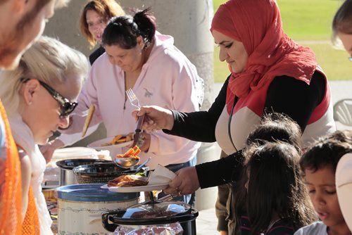 October 13, 2014 - 141013  -  Baraa Diab and her family are served by volunteers during a KidBridge Thanksgiving feast. KidBridge launched their "First Nations, All Nations: Setting the Table" project with a intercultural Thanksgiving potluck feast at The Forks  Monday, October 13, 2014. John Woods / Winnipeg Free Press