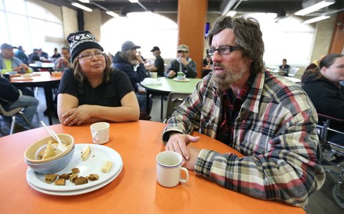 Katie Pelly and Phillip Elder chat after eating at the annual Thanksgiving meal at Siloam Mission in Winnipeg, on Sun., Oct. 12, 2014. Photo by Jason Halstead/Winnipeg Free Press