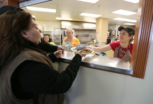 Volunteer Meridith Penner serves up meals during the annual Thanksgiving meal at Siloam Mission in Winnipeg, on Sun., Oct. 12, 2014. Photo by Jason Halstead/Winnipeg Free Press