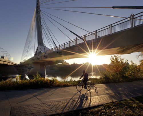 The sun rises Tuesday morning behind¤Esplanade Riel pedestrian bridge to start ¤another fine autumn day. Wayne Glowacki/Winnipeg Free Press Oct. 14 2014