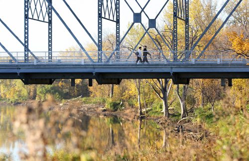 Spectacular Fall weather Passers by make their way across the  Harry Lazerenko bridge across the Red River Tuesday morning-standup Photo- Oct 14, 2014   (JOE BRYKSA / WINNIPEG FREE PRESS)