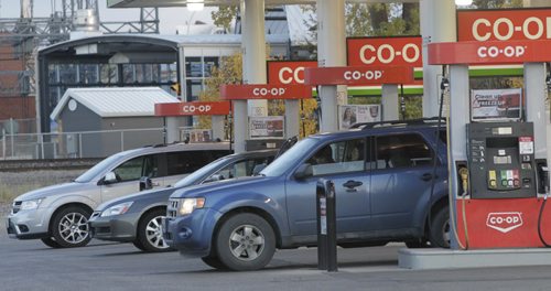 Motorists fill up Thursday morning with lower gas prices. Co-op gas bar on Osborne was selling regular fuel at 112.4. Wayne Glowacki/Winnipeg Free Press Oct. 16 2014
