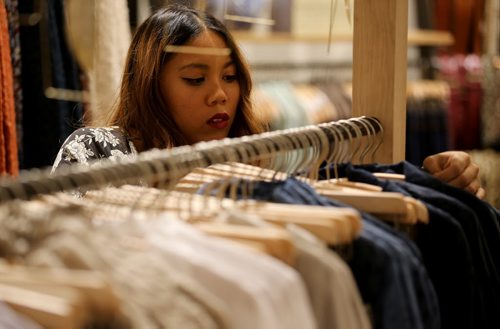 Monica Medina, 21, putting some finishing touches onto a display of clothes inside Anthropologie, which opens tomorrow in Polo Park, Thursday, October 16, 2014. (TREVOR HAGAN/WINNIPEG FREE PRESS)