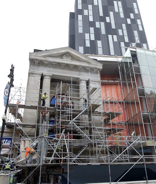 On a cool Friday morning, the scaffolding was being dismantled at the facade of the former Mitchell-Copp Jewellers bld. that will be part of the  design of the new 311 Portage Ave. site under construction that will include a boutique hotel, premium dining and office space.    Wayne Glowacki / Winnipeg Free Press Oct.16 2014