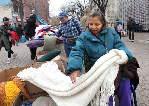 Mary Hotomani crippled with painful arthritis makes her way around the tables of clothing at the clothing market in Old Market Square Saturday   in her wheelchair as she looks for warm clothing and blankets for the winter.   The market was organized by Devoted to You ministries, civic action for the homeless and less fortunate and held in Market Square.  Ron Aldridge, a longtime advocate for the homeless oversees the event.  Standup photos Oct 17,  2014 Ruth Bonneville / Winnipeg Free Press