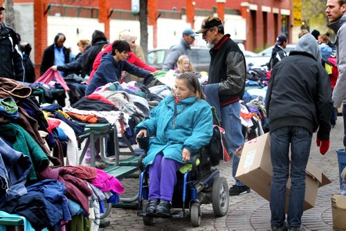 Mary Hotomani crippled with painful arthritis makes her way around the tables of clothing at the clothing market in Old Market Square Saturday   in her wheelchair as she looks for warm clothing and blankets for the winter.   The market was organized by Devoted to You ministries, civic action for the homeless and less fortunate and held in Market Square.  Ron Aldridge, a longtime advocate for the homeless oversees the event.  Standup photos Oct 17,  2014 Ruth Bonneville / Winnipeg Free Press