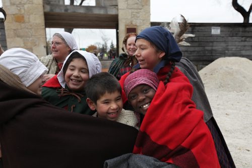 Students play together dressed 1860's period costume as they attend the unveiling of the Upper Fort Garry Provincial Park  Saturday. Oct 17,  2014 Ruth Bonneville / Winnipeg Free Press