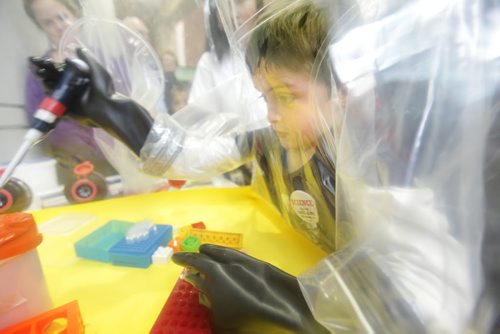 Six year old Jim Spreitzer learns what it's like to do experiments using thick rubber gloves in a imitation test lab at the National Microbiology Lab open house Saturday celebrating its 15th anniversary.   Oct 17,  2014 Ruth Bonneville / Winnipeg Free Press