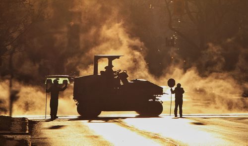 Steam rises off new asphalt being installed on Balmoral Street at Cumberland Avenue early Sunday morning.  141019 October 19, 2014 Mike Deal / Winnipeg Free Press