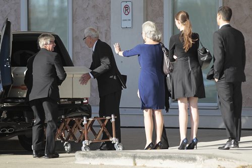October 19, 2014 - 141019  - Family wave goodbye to Ken Epp, who helped grow music education in the province during his 29 years as Executive Director of the Manitoba Band Association, as his casket is place in a hearse at North Kildonan MB Church Sunday, October 19, 2014. The band was comprised of band teachers, members of various local bands and former students.  John Woods / Winnipeg Free Press