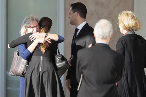 October 19, 2014 - 141019  -  Family members hug after the funeral of  Ken Epp, who helped grow music education in the province during his 29 years as Executive Director of the Manitoba Band Association at North Kildonan MB Church Sunday, October 19, 2014. The band was comprised of band teachers, members of various local bands and former students.  John Woods / Winnipeg Free Press