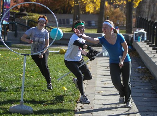 Members of the Winnipeg Whomping Willows Quidditch team Renata Hrymdzio (right) tosses the snitch through a hoop during an open practice at The Forks in an effort to drum up interest in the game. 141019 - Sunday, October 19, 2014 -  (MIKE DEAL / WINNIPEG FREE PRESS)