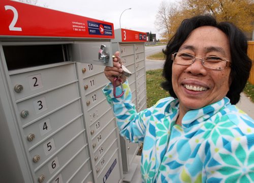 Leonora Lipato  checks mail in her pajamas new Canada Post community mailboxes at Jefferson Ave and Adsum St Monday morning See Adam Wazny story - Oct 20, 2014   (JOE BRYKSA / WINNIPEG FREE PRESS)