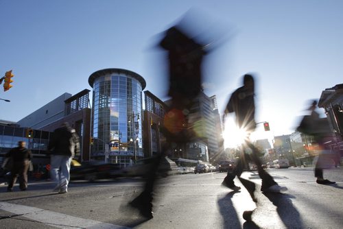 October 20, 2014 - 141020  -  Pedestrians cross Portage Avenue at Donald and the MTS Centre Monday, October 20, 2014. John Woods / Winnipeg Free Press