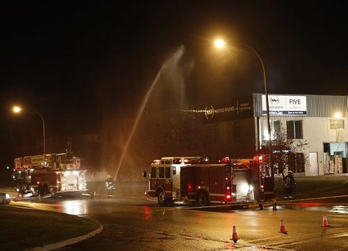 LOCAL . Wpg Fire fighters responded to a fire in the roof of Wood Wyant on Mountain Ave at Bentall St. about 6:30am .Oct. 21 2014 / KEN GIGLIOTTI / WINNIPEG FREE PRESS